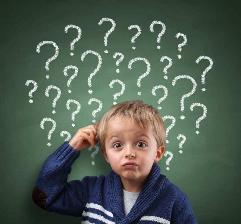 Child scratching head with question mark on blackboard concept f
