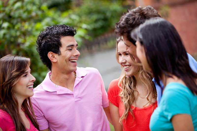 Group of casual young people talking outdoors