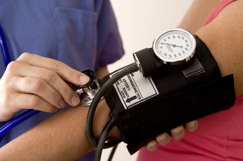 Doctor or nurse taking a patient's blood pressure
