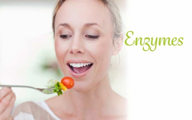 The word enzymes against woman eating a tomato
