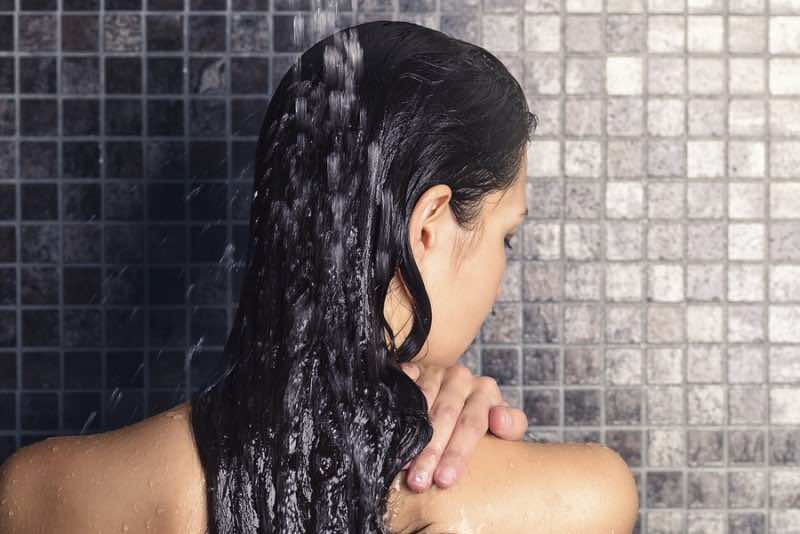Young Woman Washing Her Long Hair Under The Shower