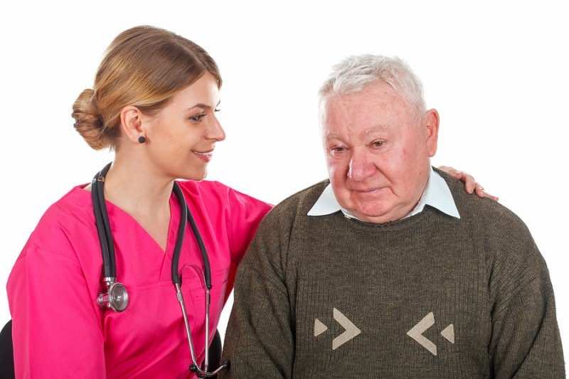 Picture of a depressed old man with her young doctor - isolated background